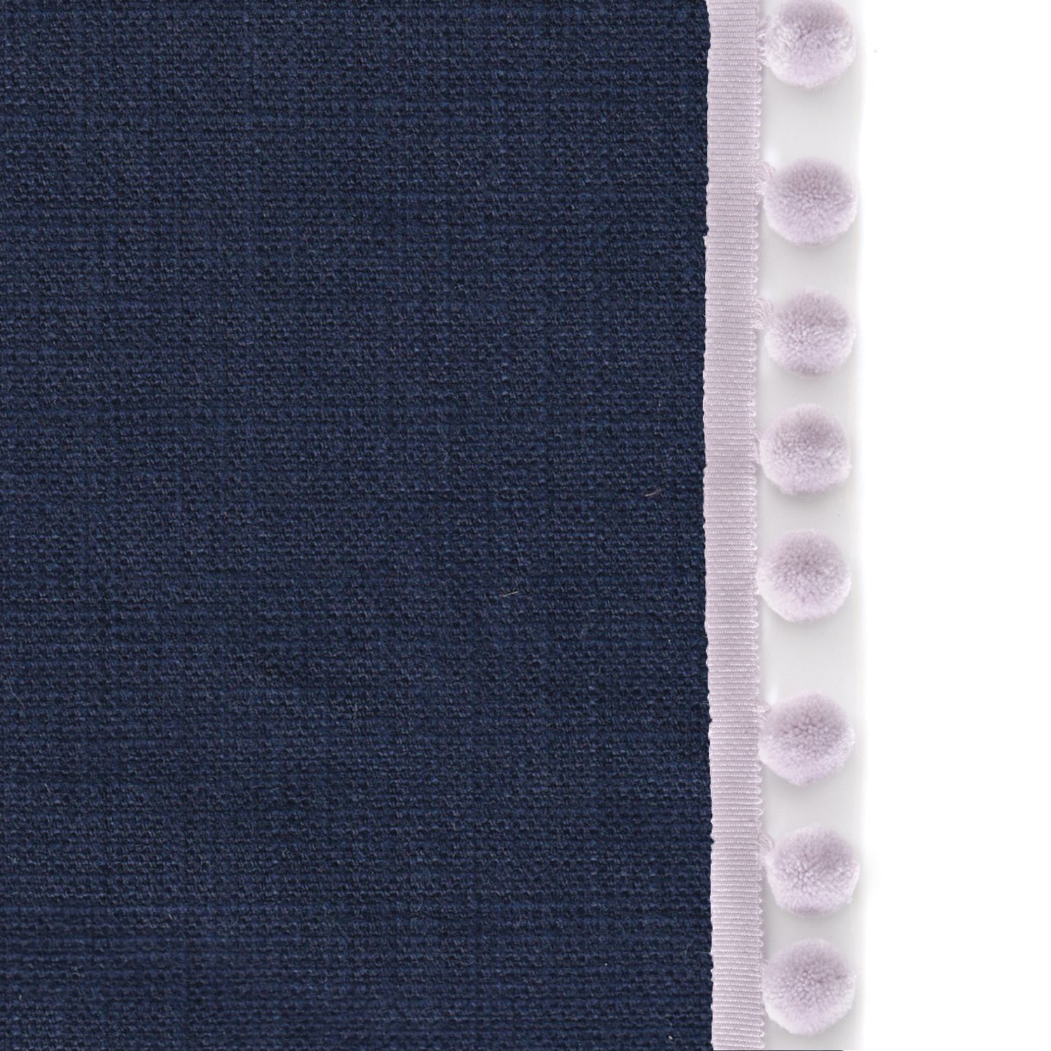 Upclose picture of Midnight custom Navy Bluecurtain with lilac pom pom trim