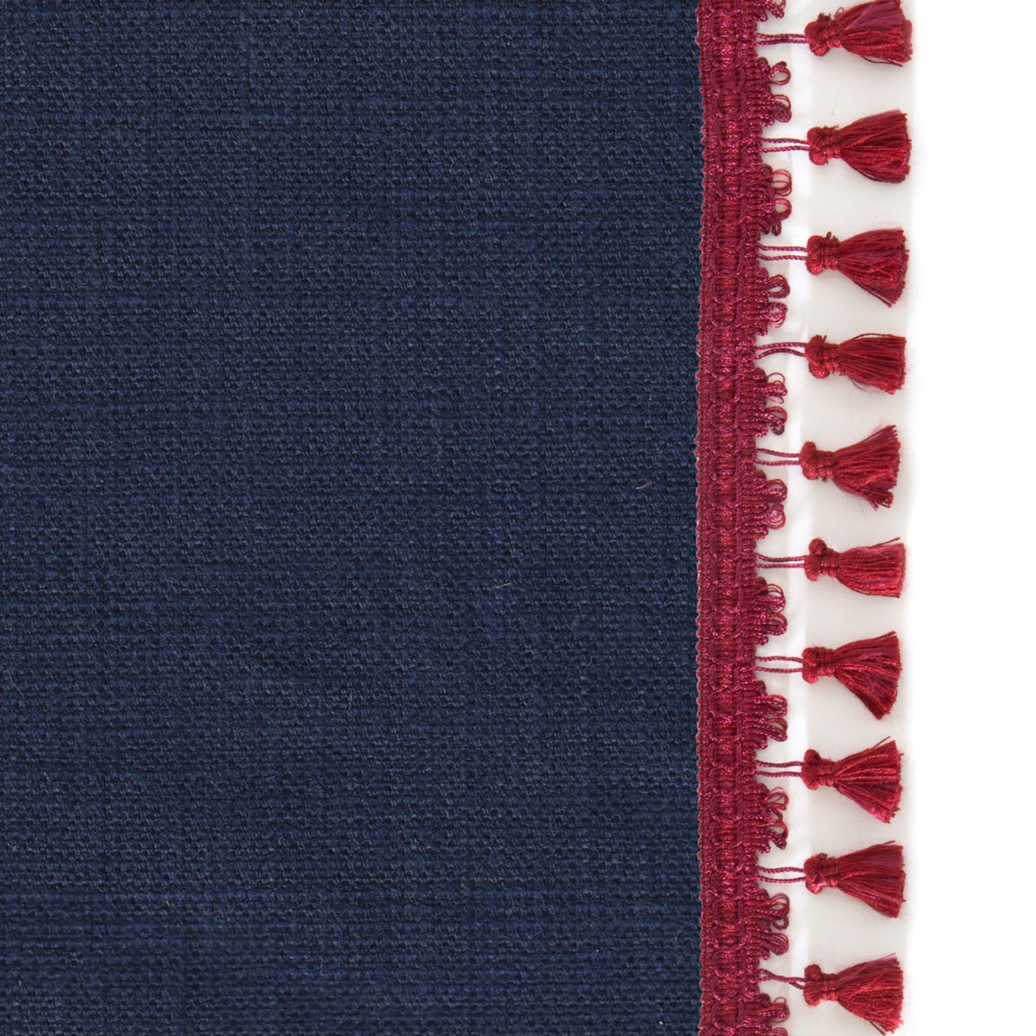 Upclose picture of Midnight custom Navy Bluecurtain with midnight raspberry tassel trim