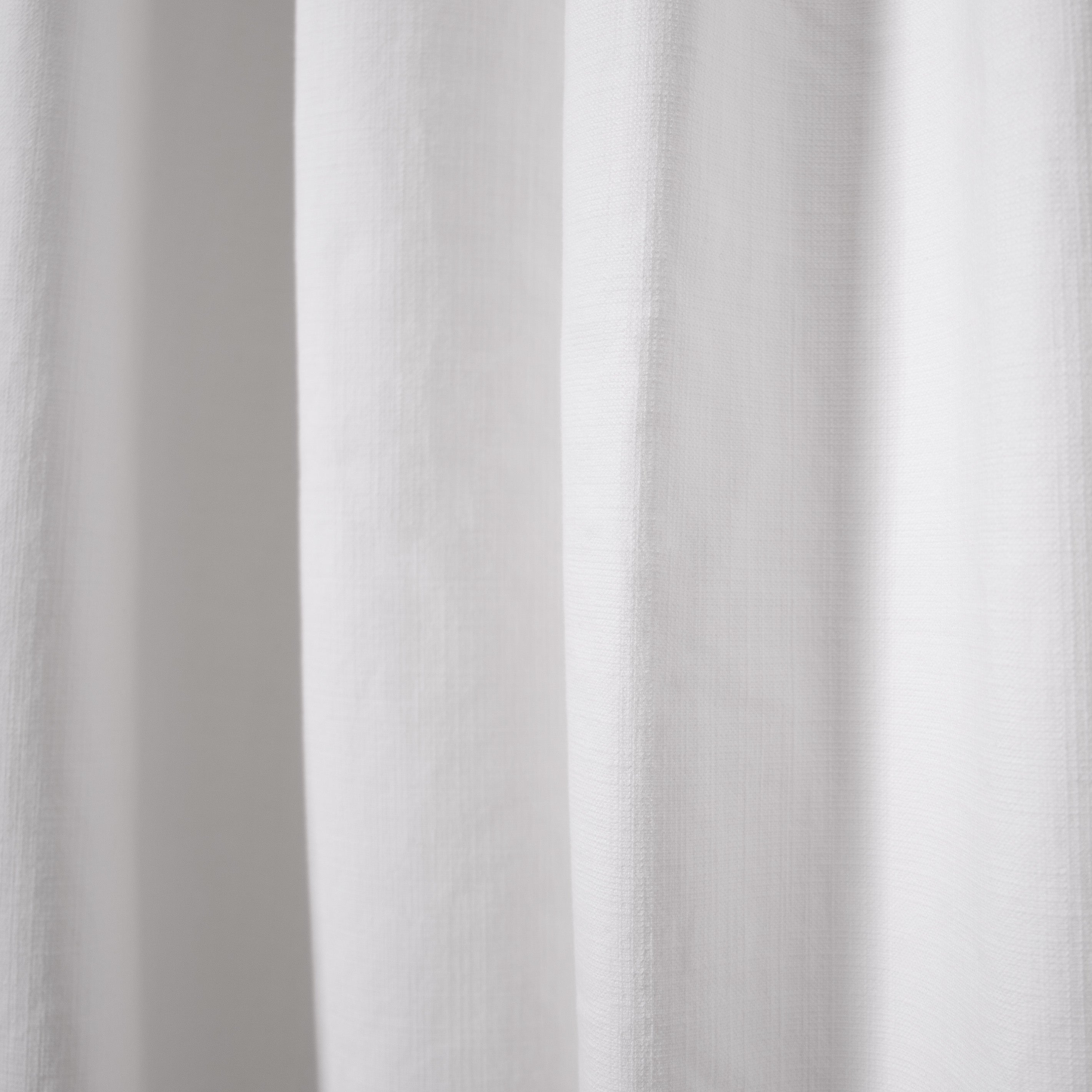 close up of white fabric curtain 