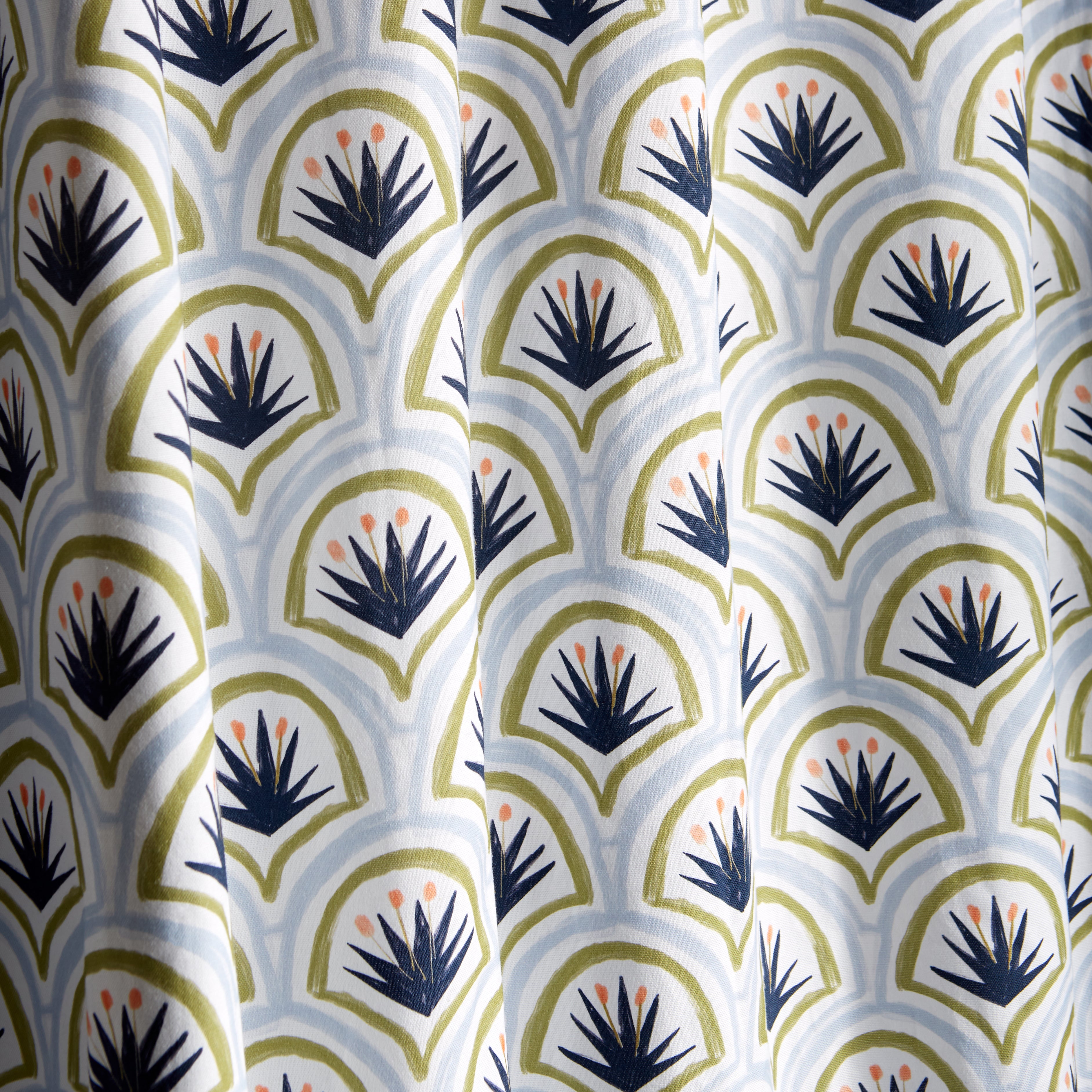 close up of blue and green art deco palm pattern curtain 