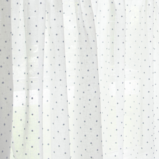 close up of white curtain with sky blue polka dots