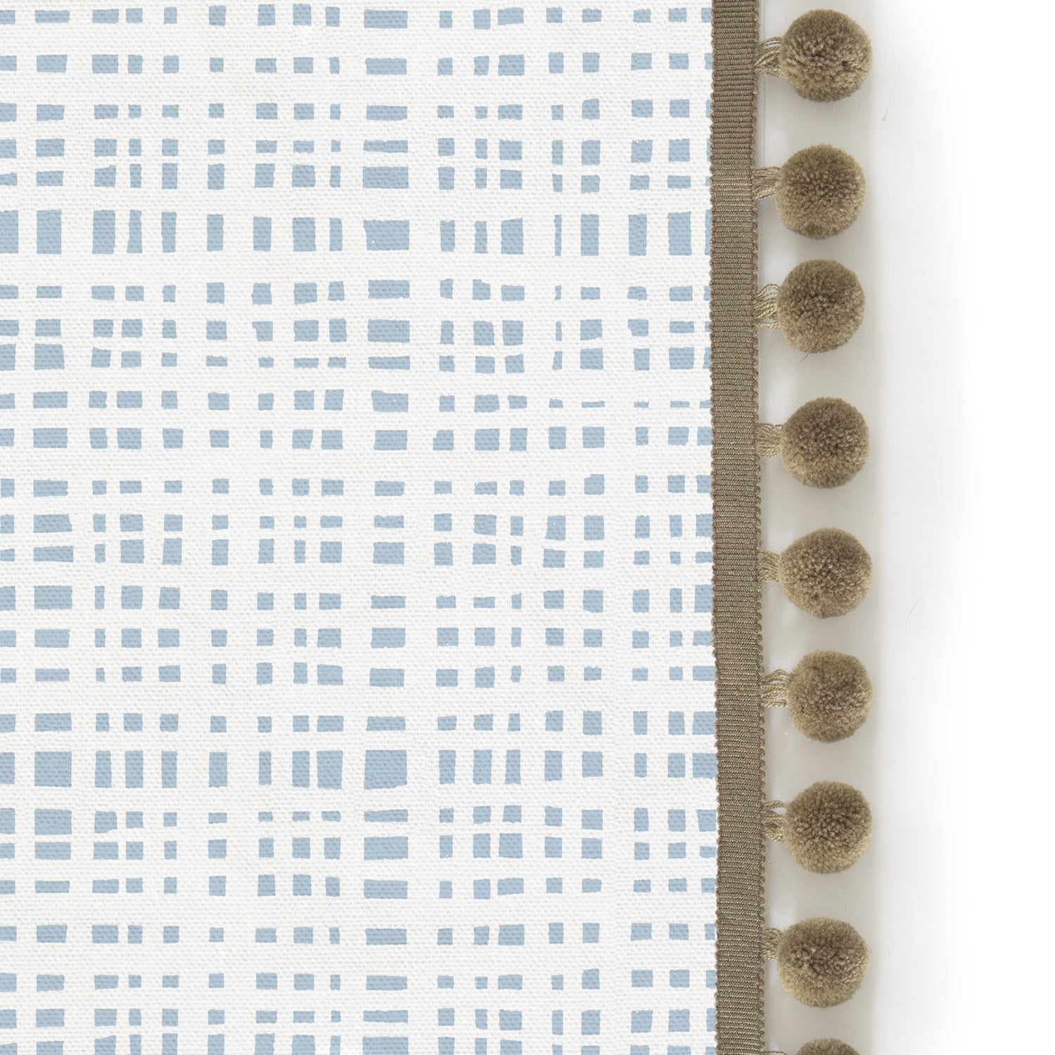 Upclose picture of Ginger Sky custom shower curtain with olive pom pom trim