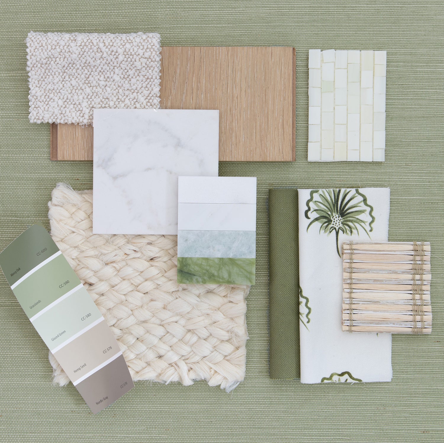 interior design mood board with moss green linen fabric swatch, floral moss green fabric swatch, neutral tile samples, and green and neutral paint swatches