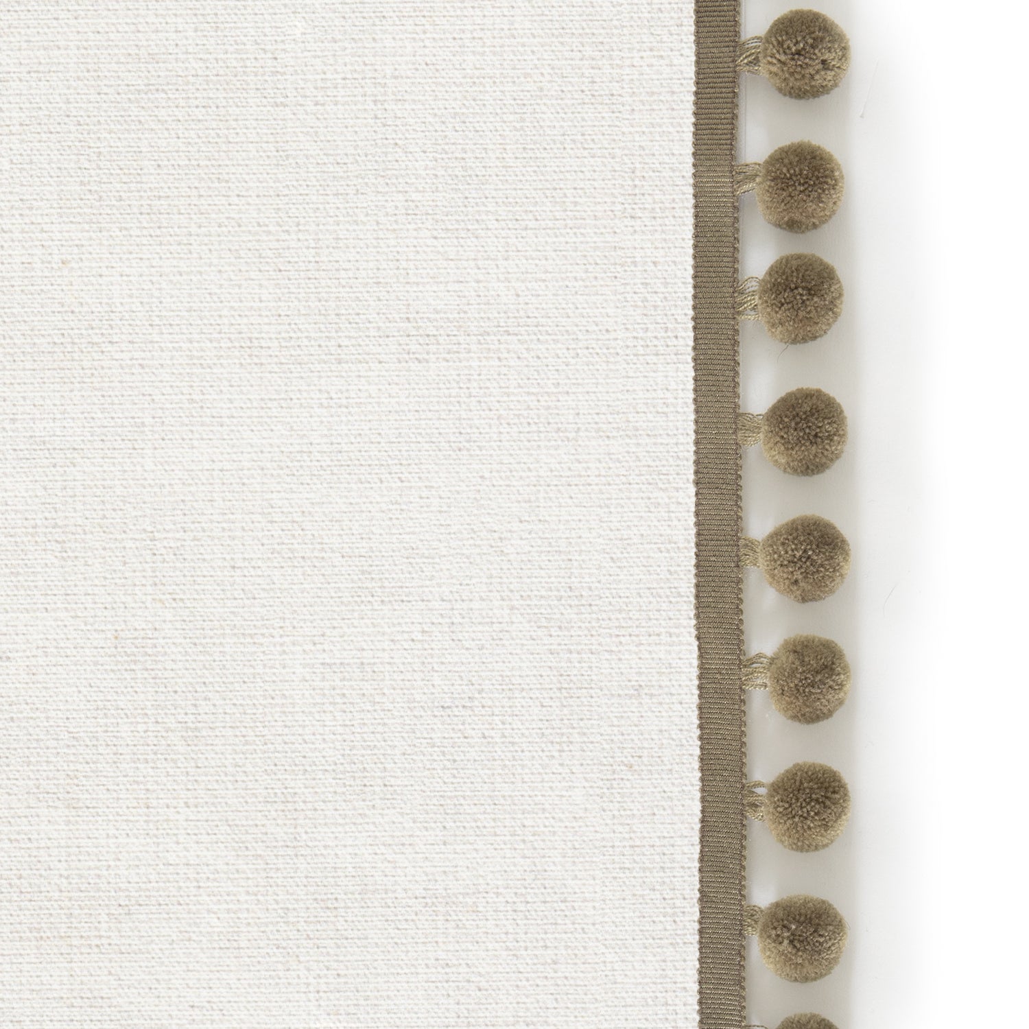 Upclose picture of Flour custom Natural Whiteshower curtain with olive pom pom trim