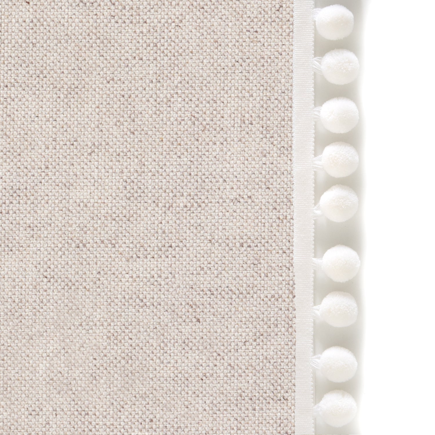 Upclose picture of Oat custom Linen Oatcurtain with snow pom pom trim