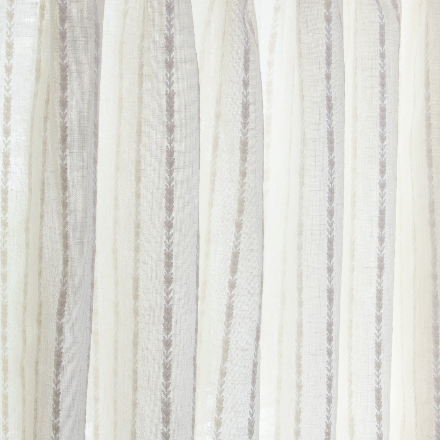 close up of natural white curtain with neutral stripe pattern