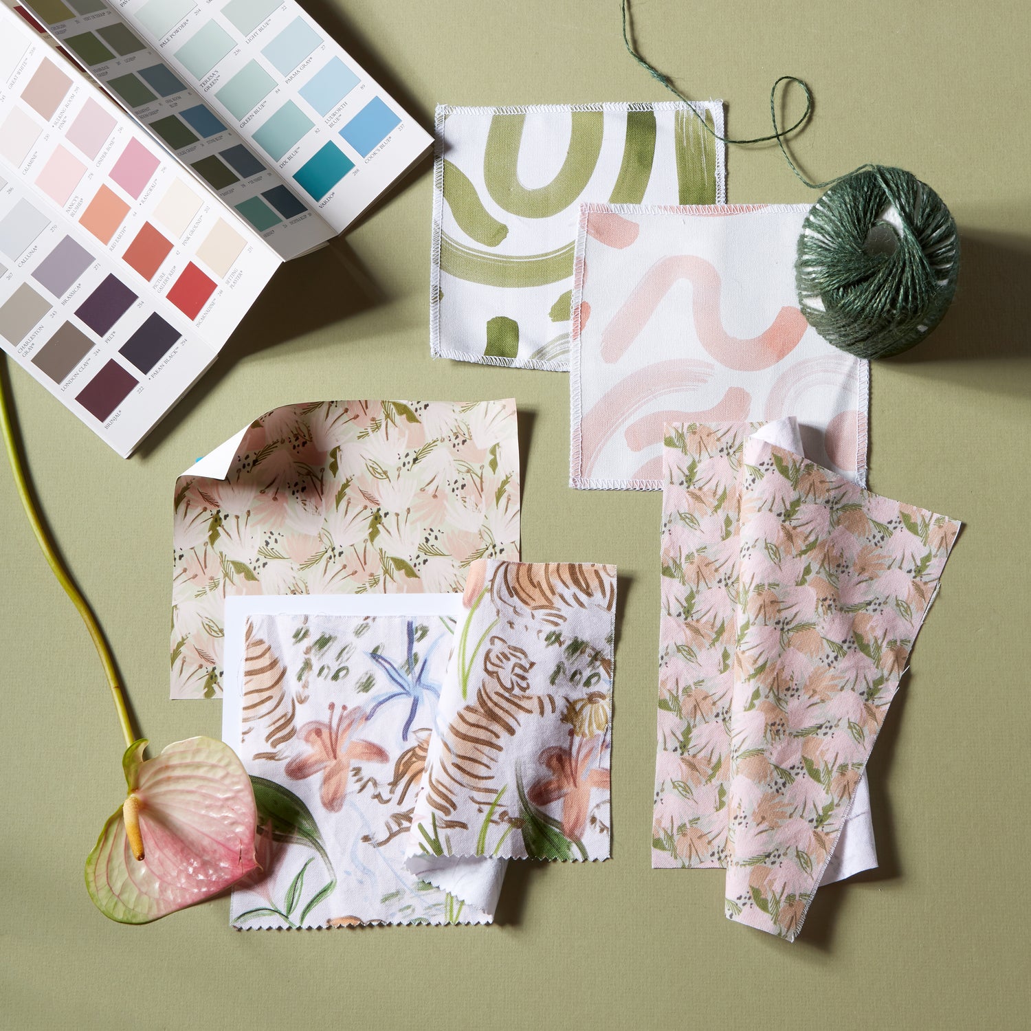 interior design mood board with Moss Green Printed Cotton Swatch multi colored paint swatches and pink abstract printed cotton fabric swatches