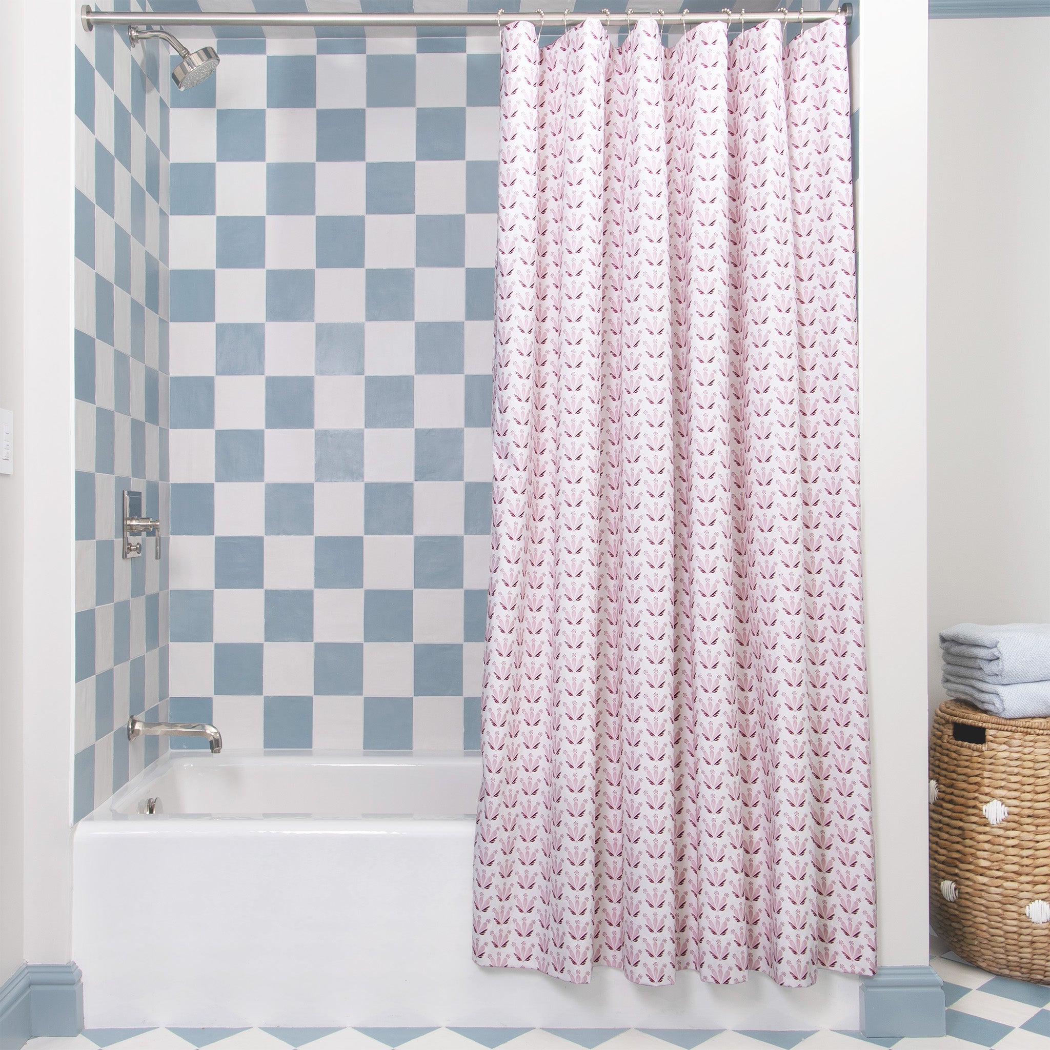 Pink & Burgundy Drop Repeat Floral Printed shower curtain hanging on rod in front of white tub in bathroom with blue and white tiles