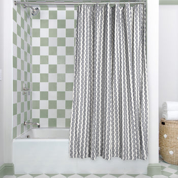 Beatrice custom embroidered linen shower curtain in a modern bathroom with green checkered tiles.