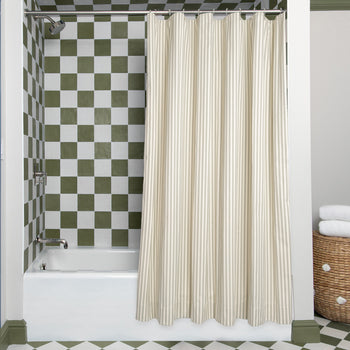 Louisa Sage Unlined shower curtain in a stylish bathroom with green checkered tile and white bathtub view.