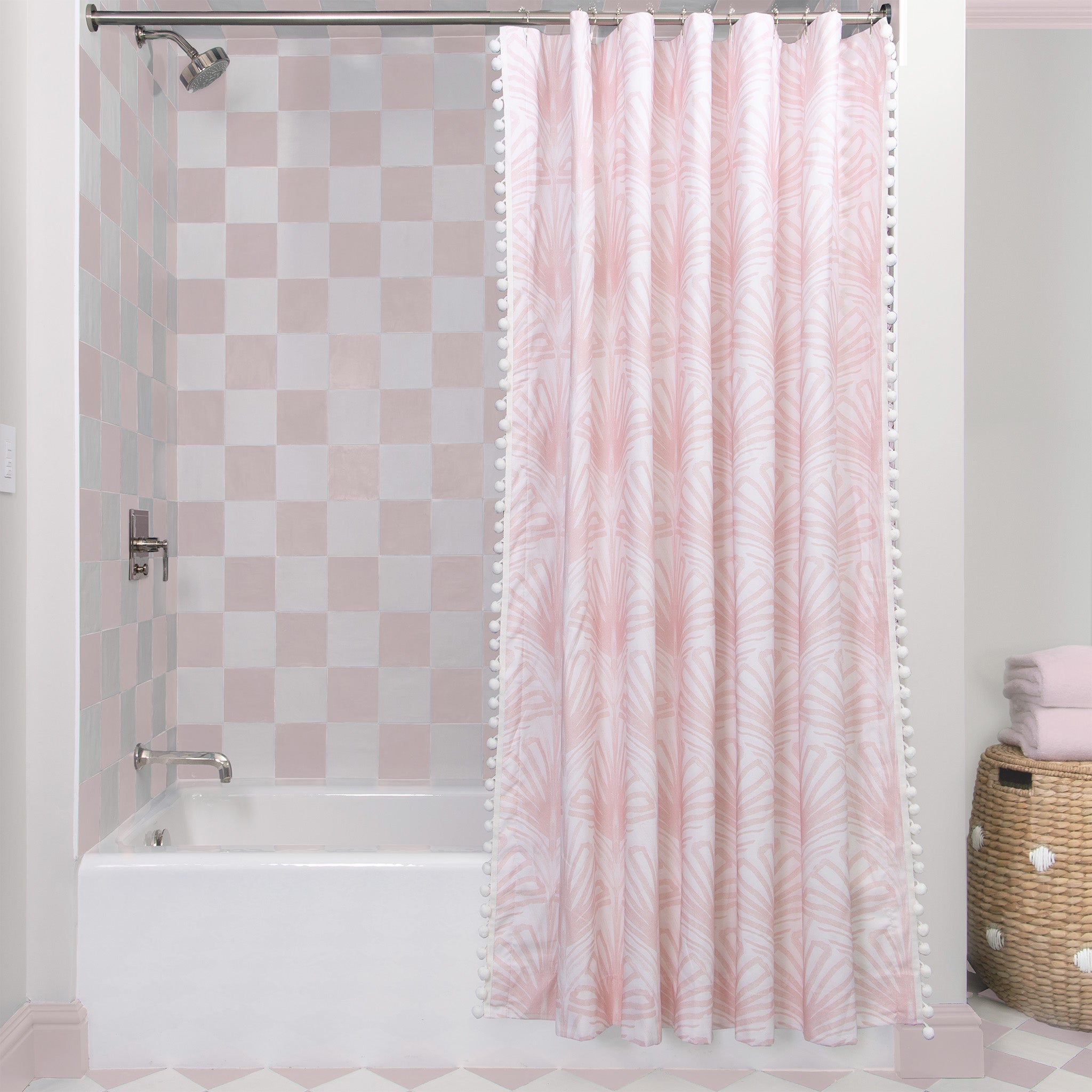 Rose Pink Art Deco Printed shower curtain hanging on rod in front of white tub in bathroom with pink and white tiles