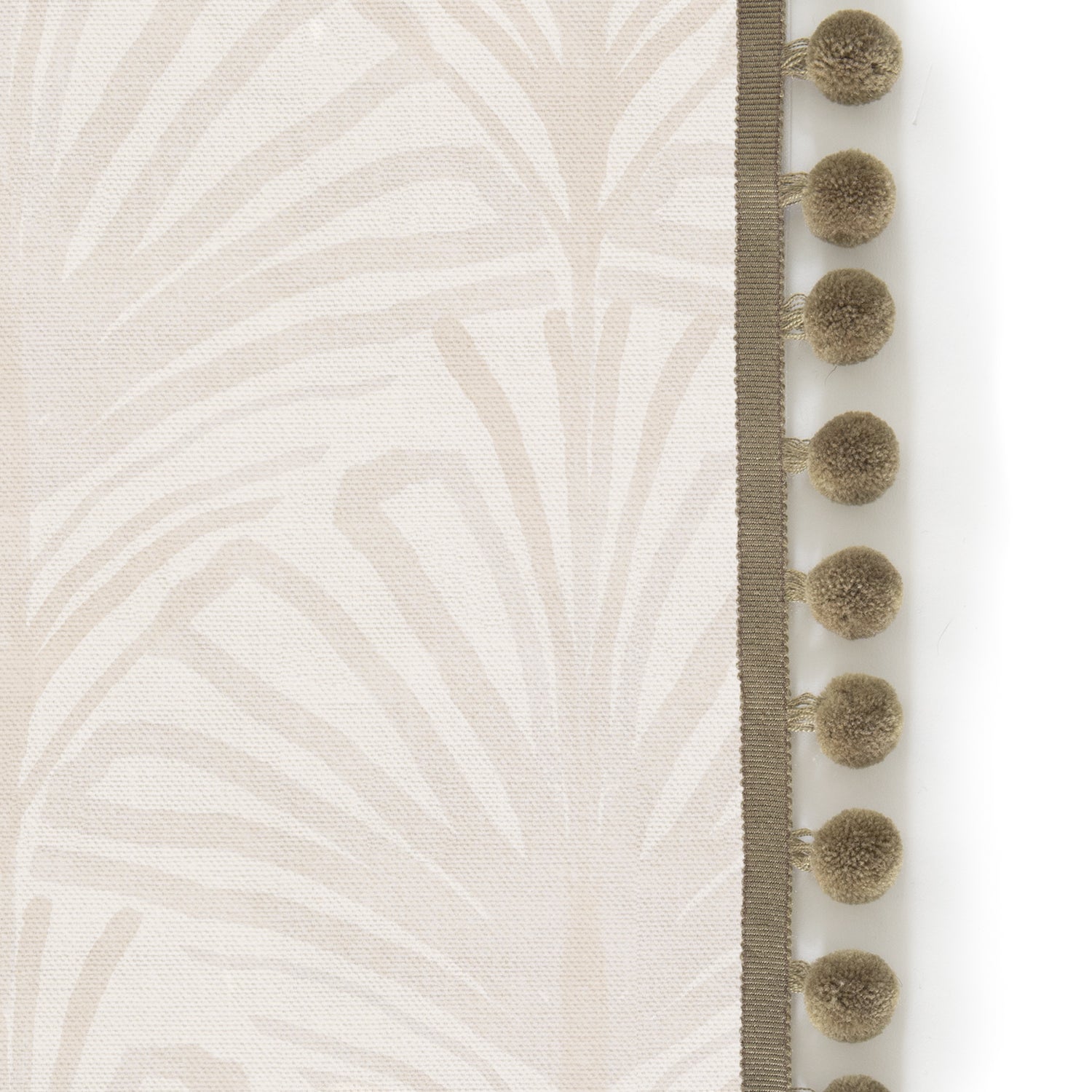 Upclose picture of Suzy Sand custom Beige Palmshower curtain with olive pom pom trim