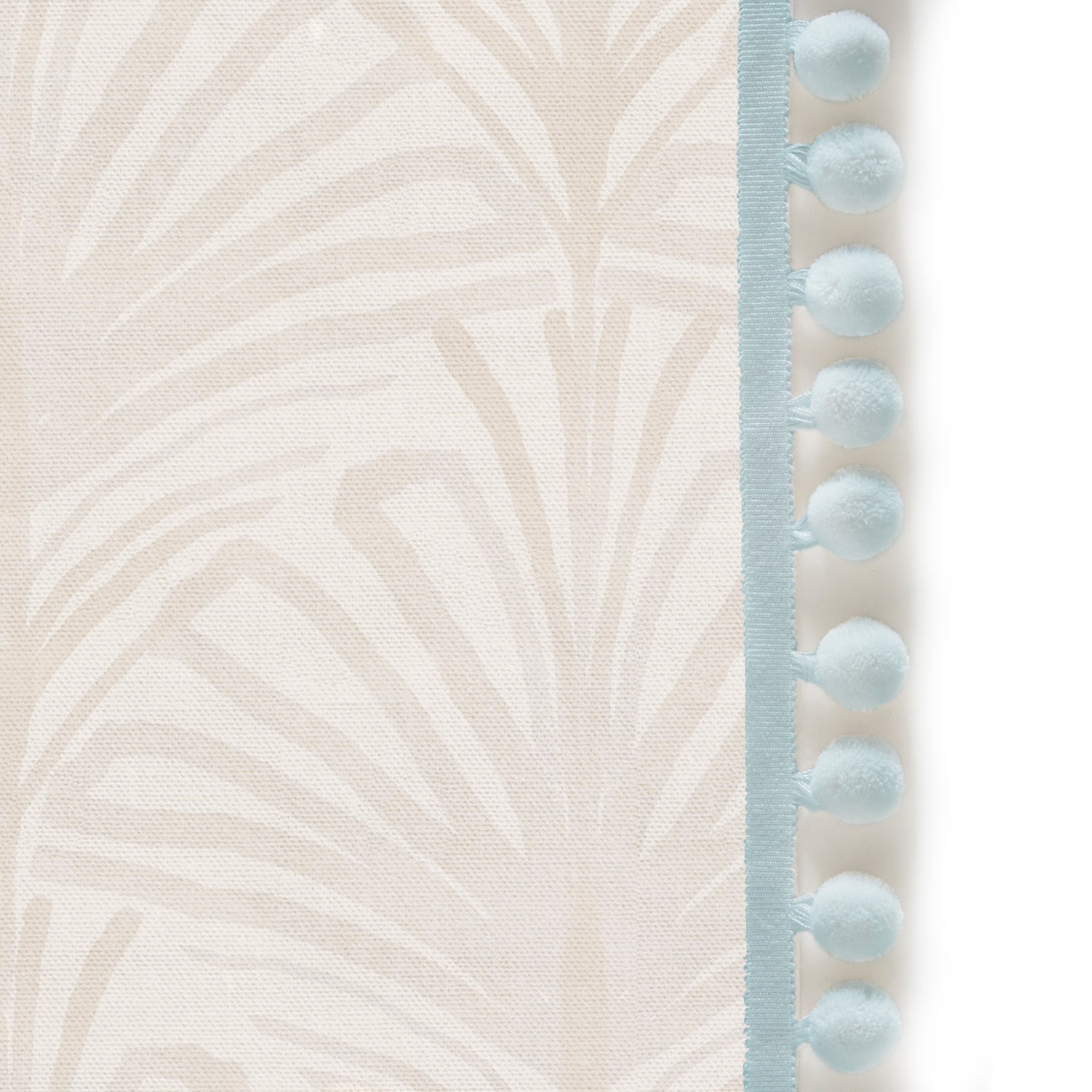 Upclose picture of Suzy Sand custom Beige Palmshower curtain with powder pom pom trim