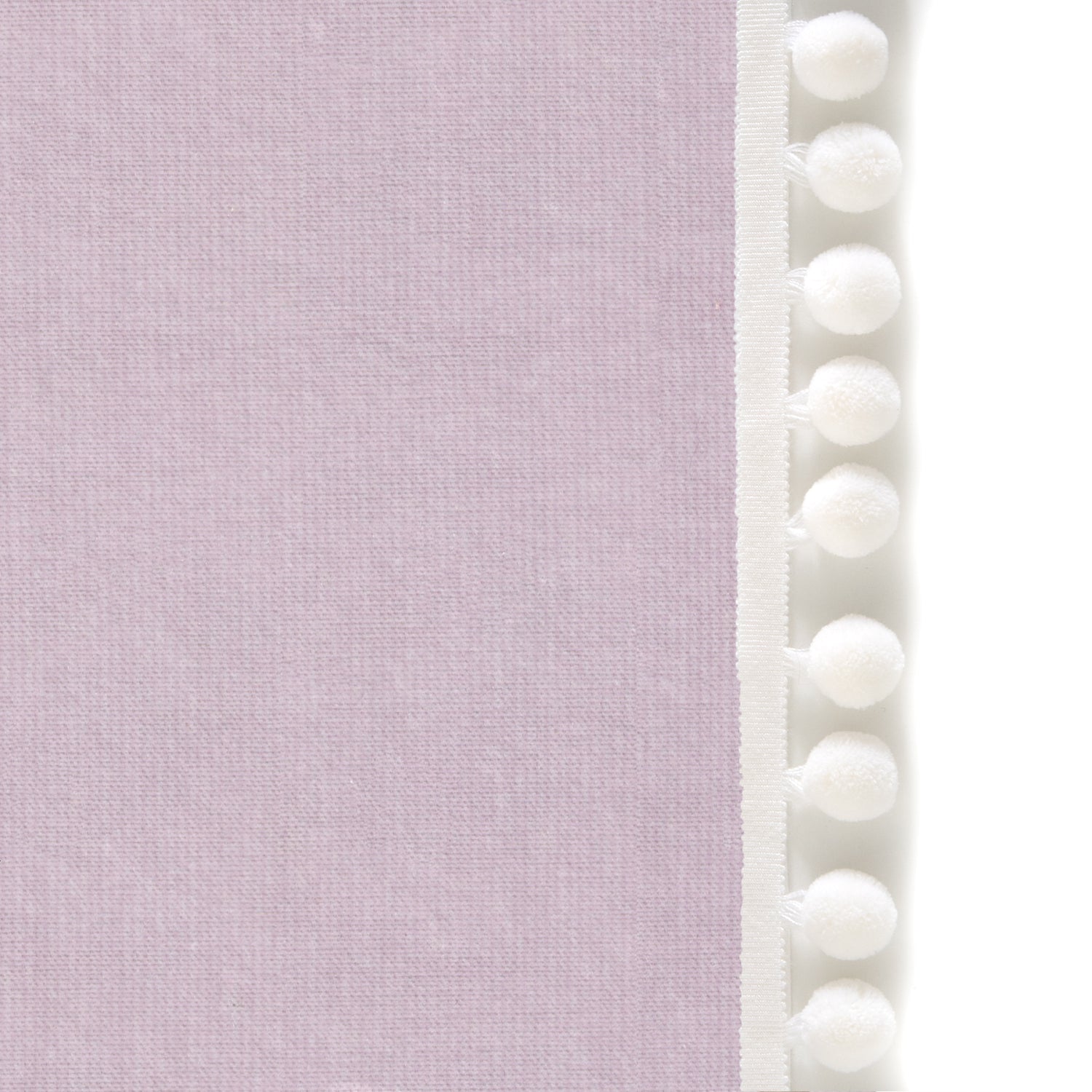 Upclose picture of Lilac Velvet custom curtain with snow pom pom trim