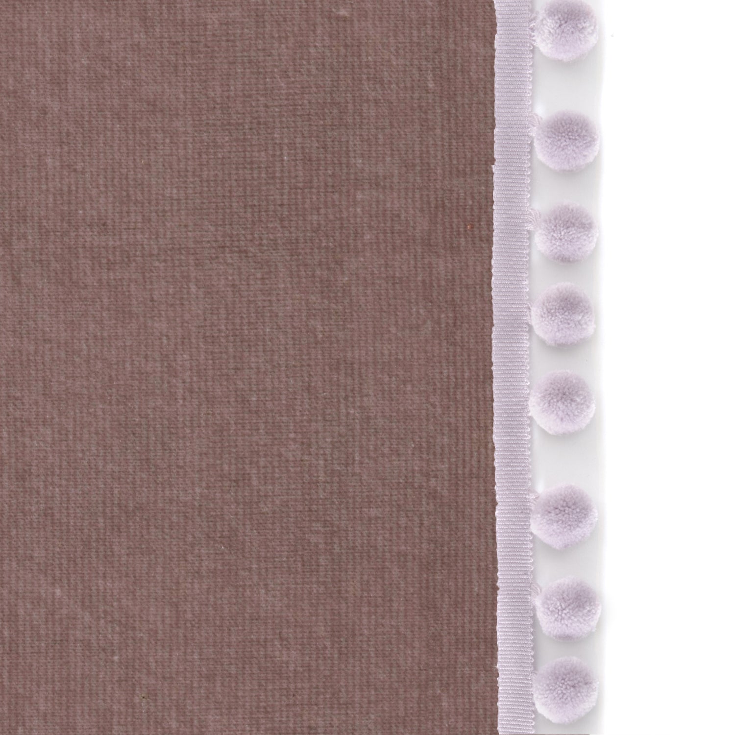 Upclose picture of Mauve Velvet custom curtain with lilac pom pom trim