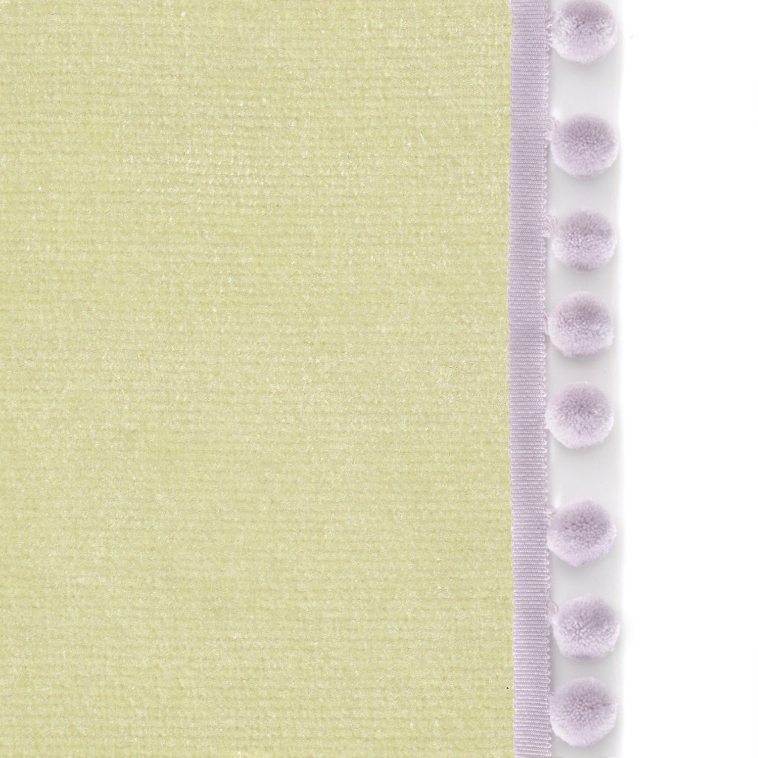 Upclose picture of Pear Velvet custom curtain with lilac pom pom trim