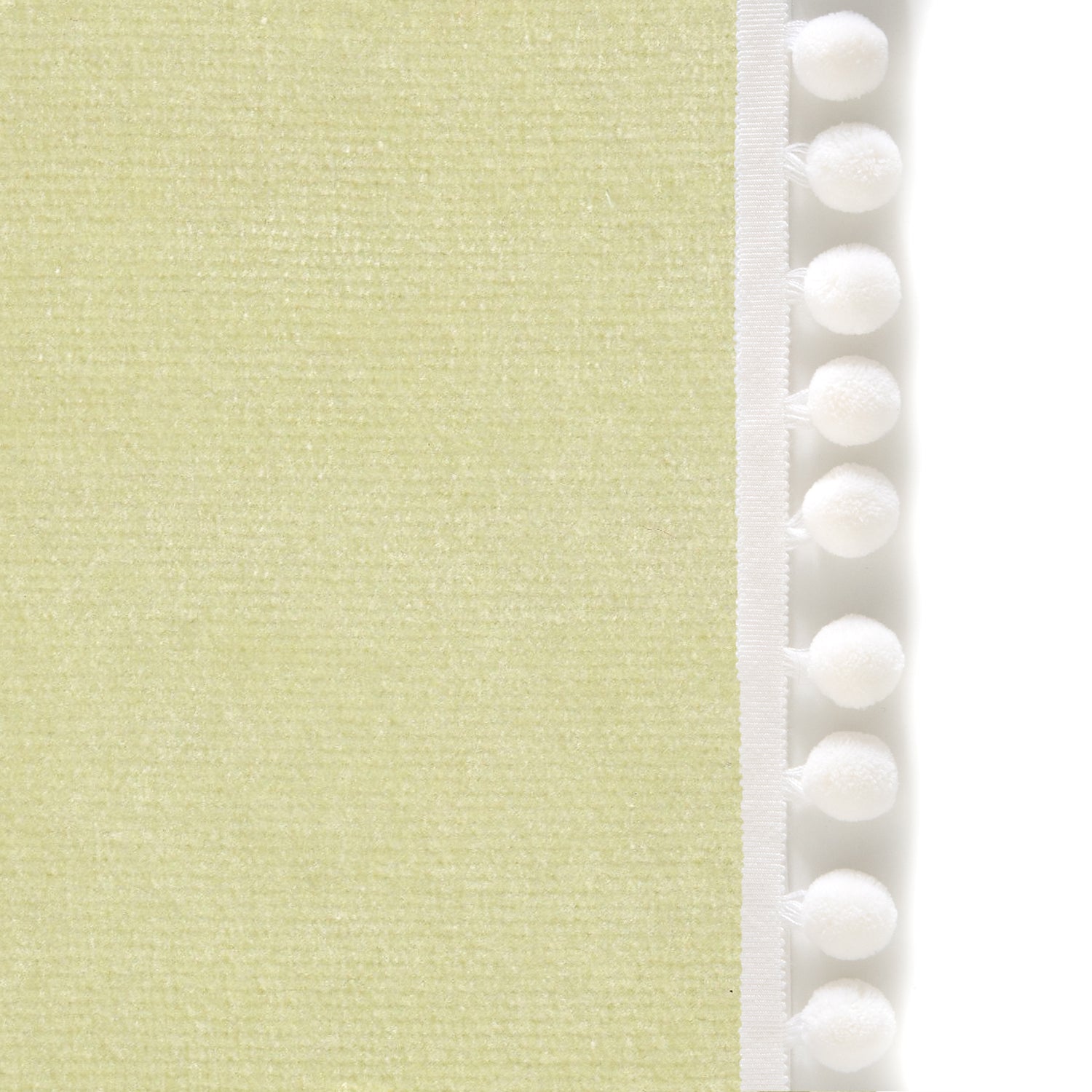 Upclose picture of Pear Velvet custom curtain with snow pom pom trim