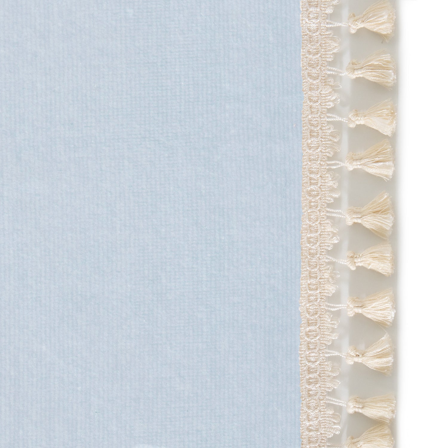 Upclose picture of Sky Velvet custom curtain with cream tassel trim