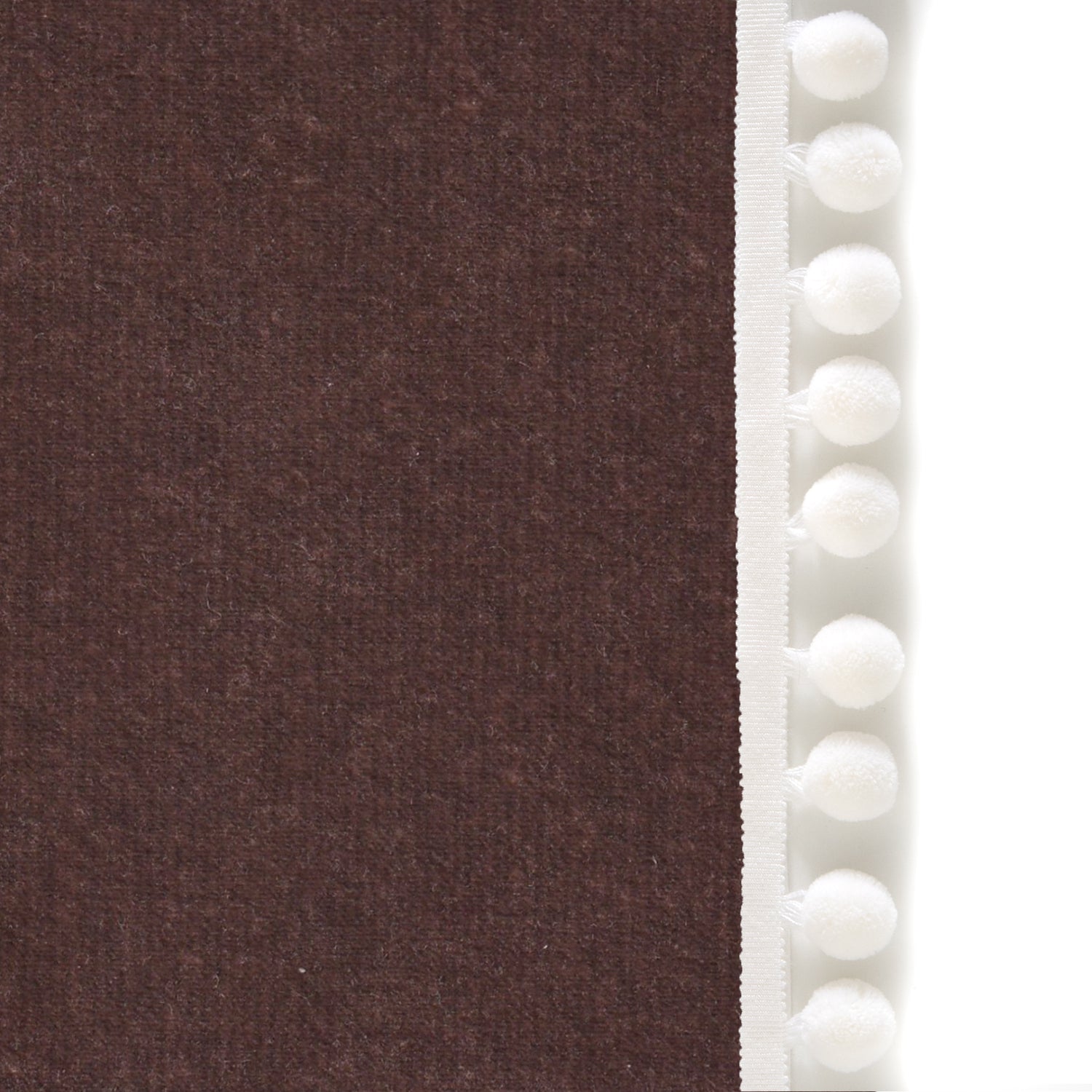 Upclose picture of Walnut Velvet custom curtain with snow pom pom trim
