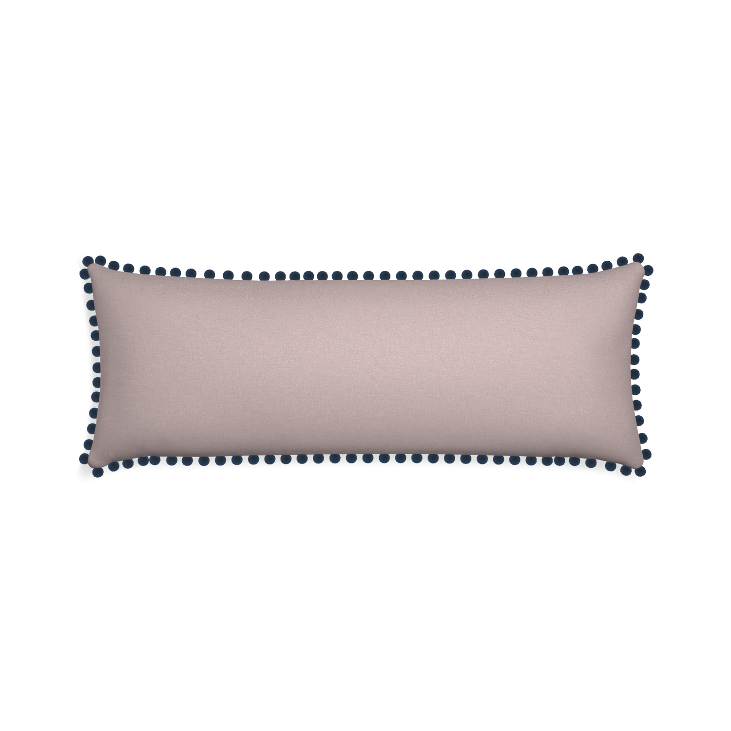 pale pink lumbar pillow with dark blue pom poms 