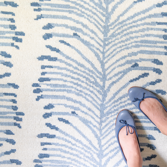 Sky Blue Botanical Stripe Printed Rug Close-up with blue shoes on woman's feet in the bottom right corner