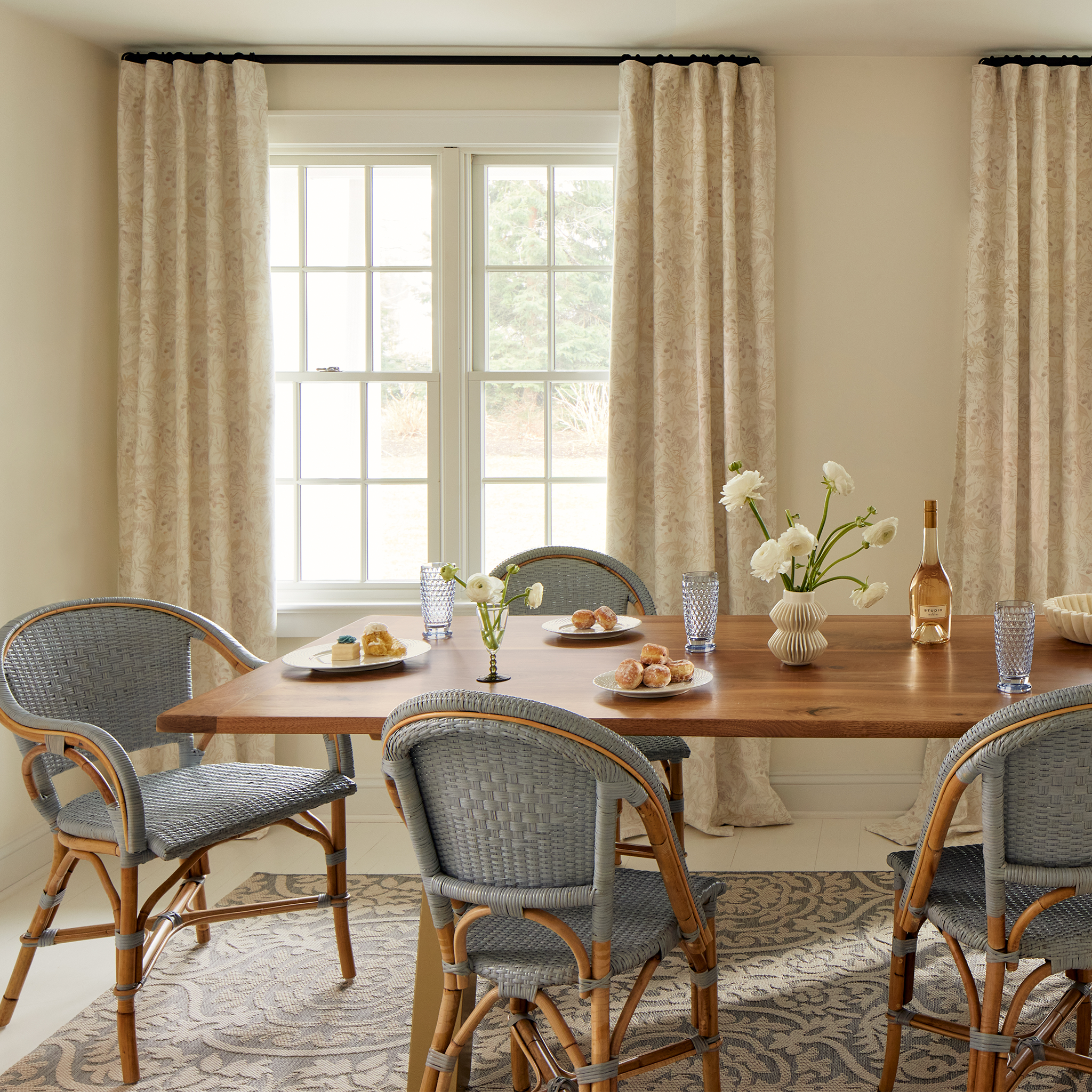 Dining room styled with Beige Chinoiserie Tiger Printed Curtains by wooden rectangular table with baby blue wooden chairs around it