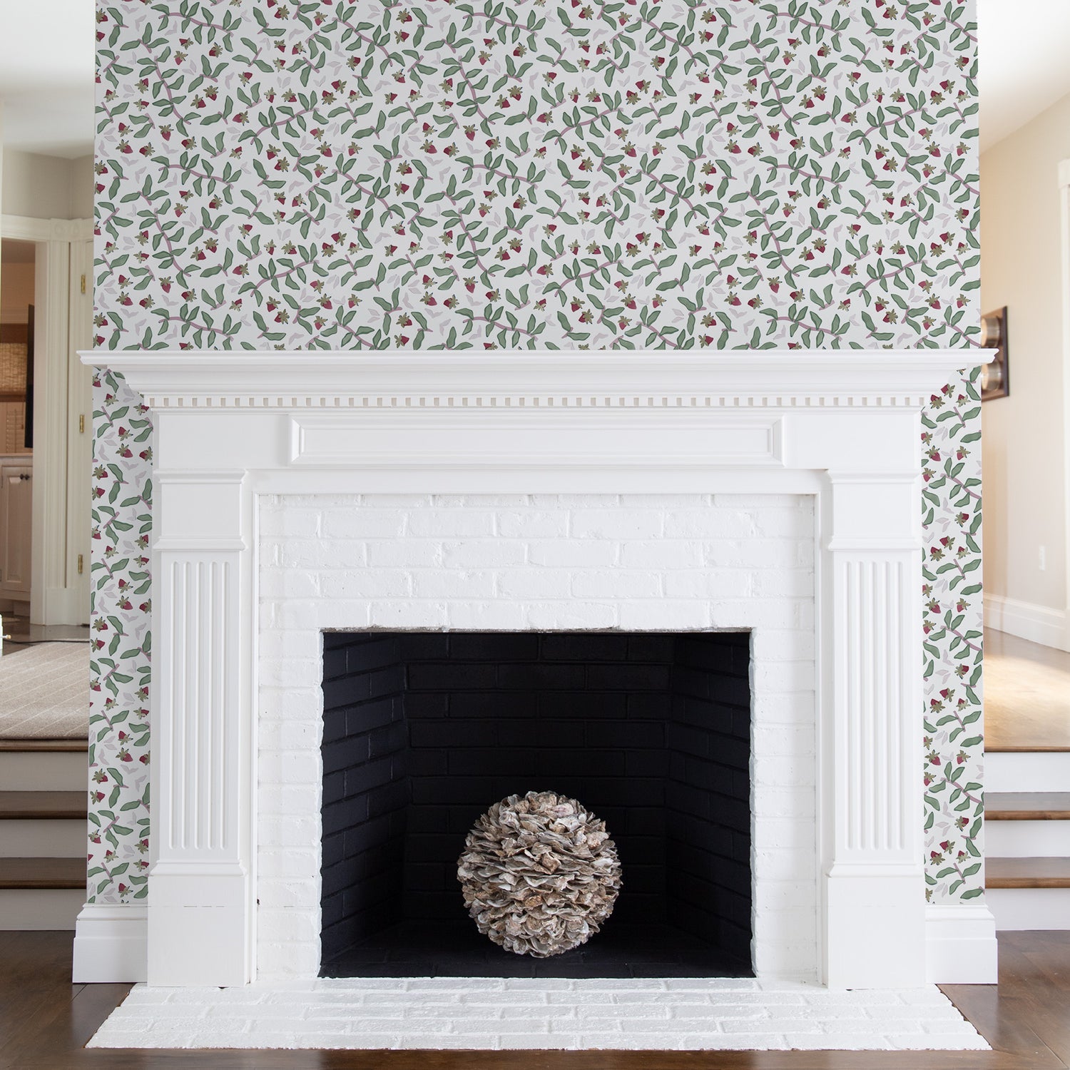 Living room fireplace styled with Strawberry & Botanical Printed Wallpaper