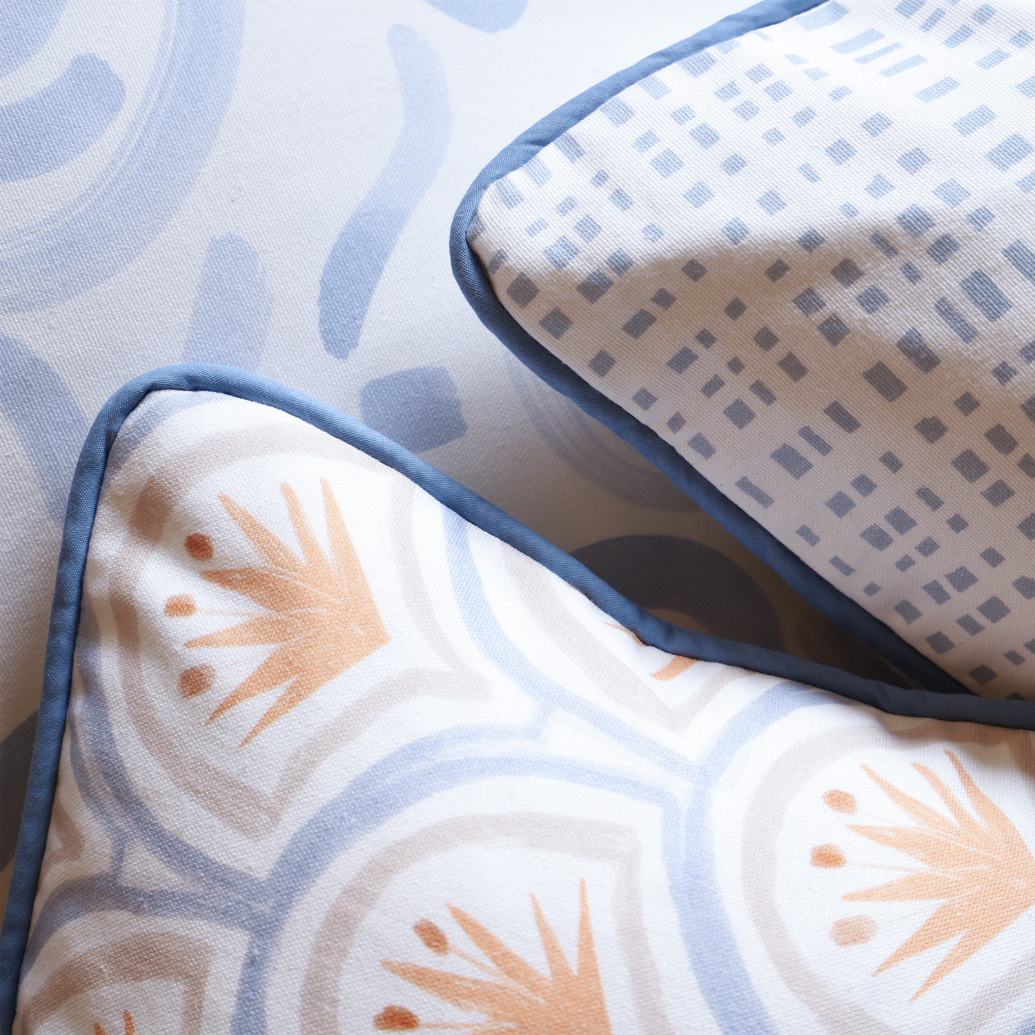 Close-up of Sky Blue Printed Pillow, Sky Blue Gingham Printed Pillow, and Art Deco Palm Pattern Printed Pillow