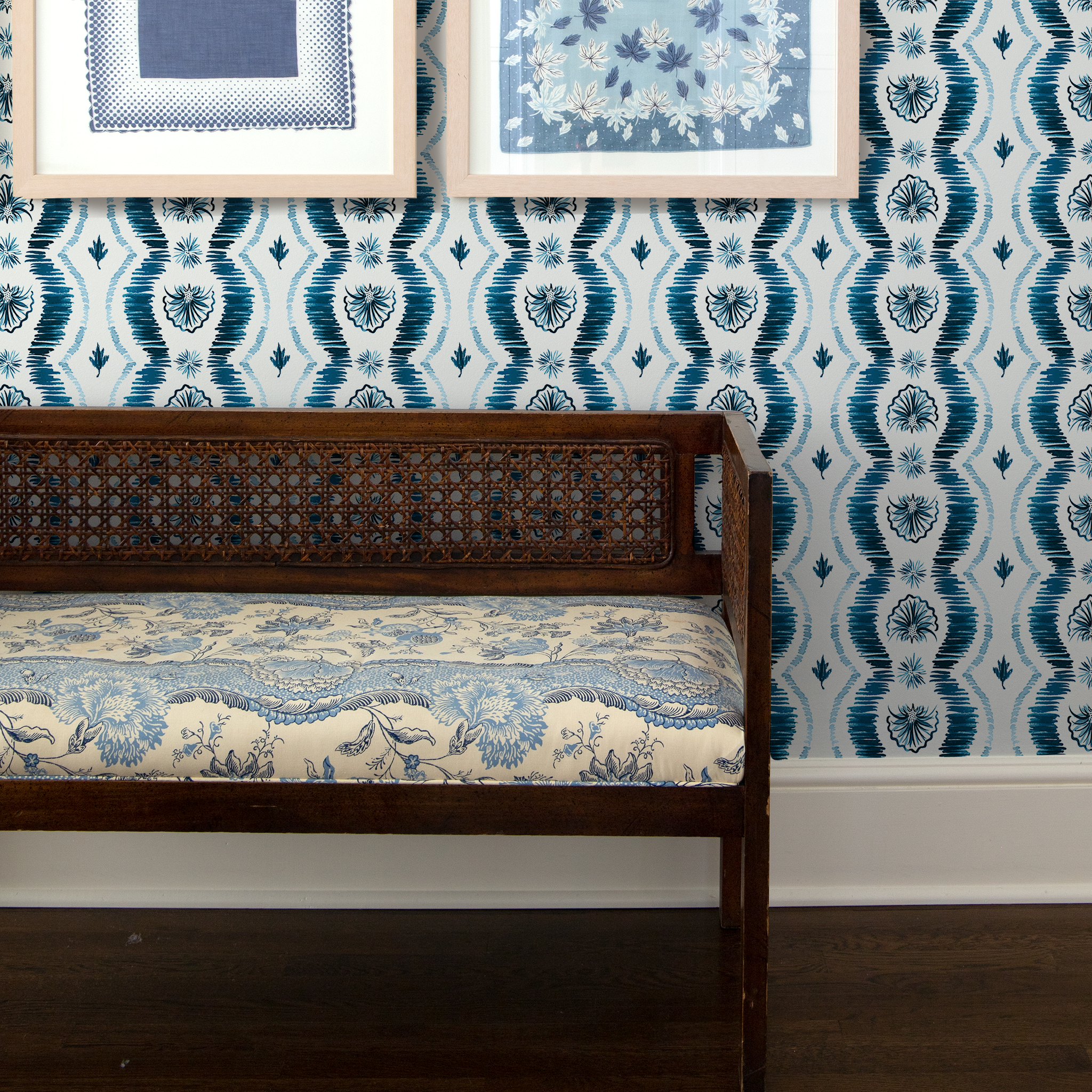 Wooden bench in front of Blue Ikat Striped Pattern Wallpaper with two paintings hanging 