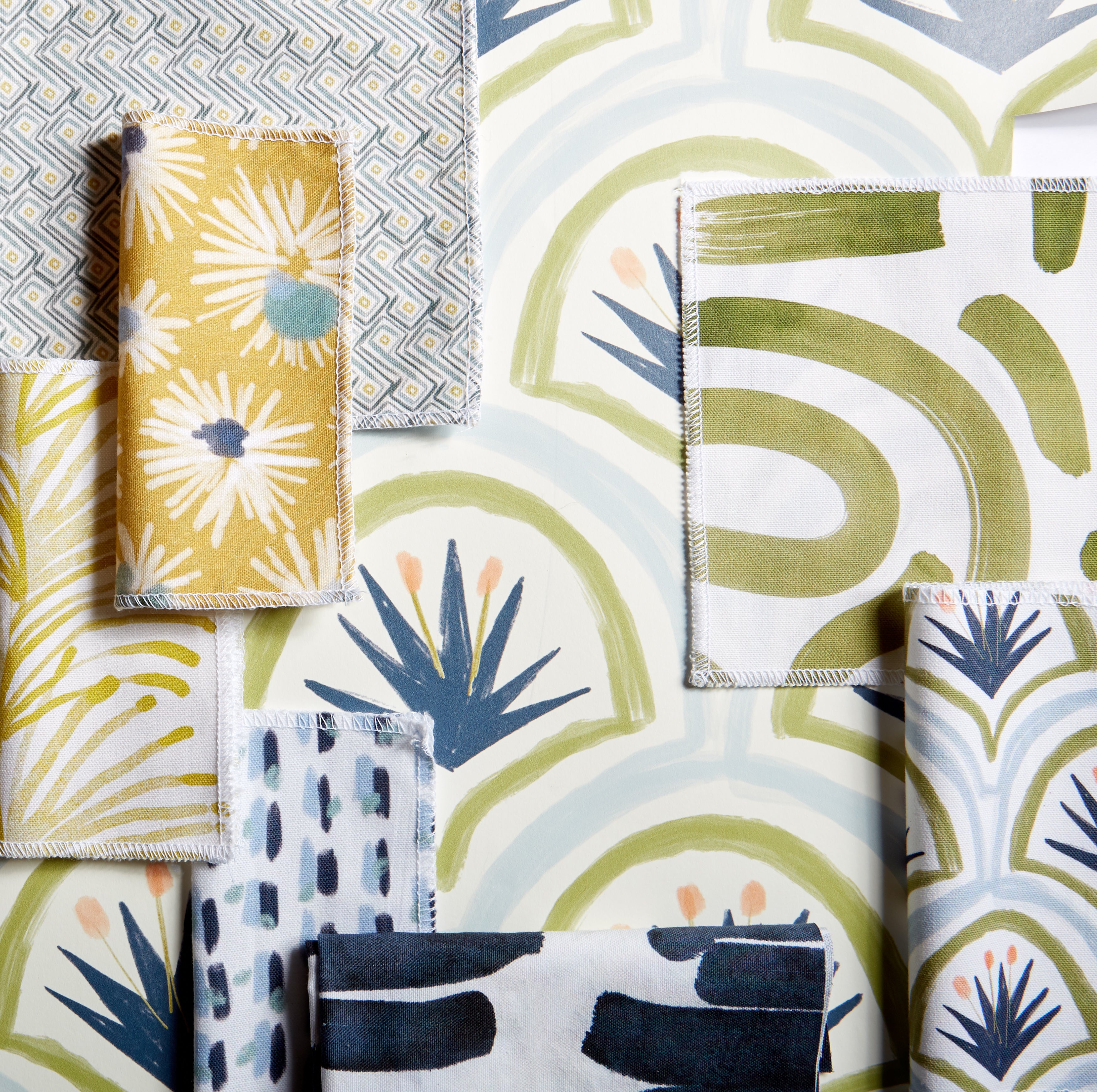Interior design moodboard and fabric inspirations with Moss Green Printed Swatch, Art Deco Palm Pattern Printed Swatch, Sky and Navy Blue Poppy Printed Swatch, and Navy Brushstokes Pattern Printed Swatch