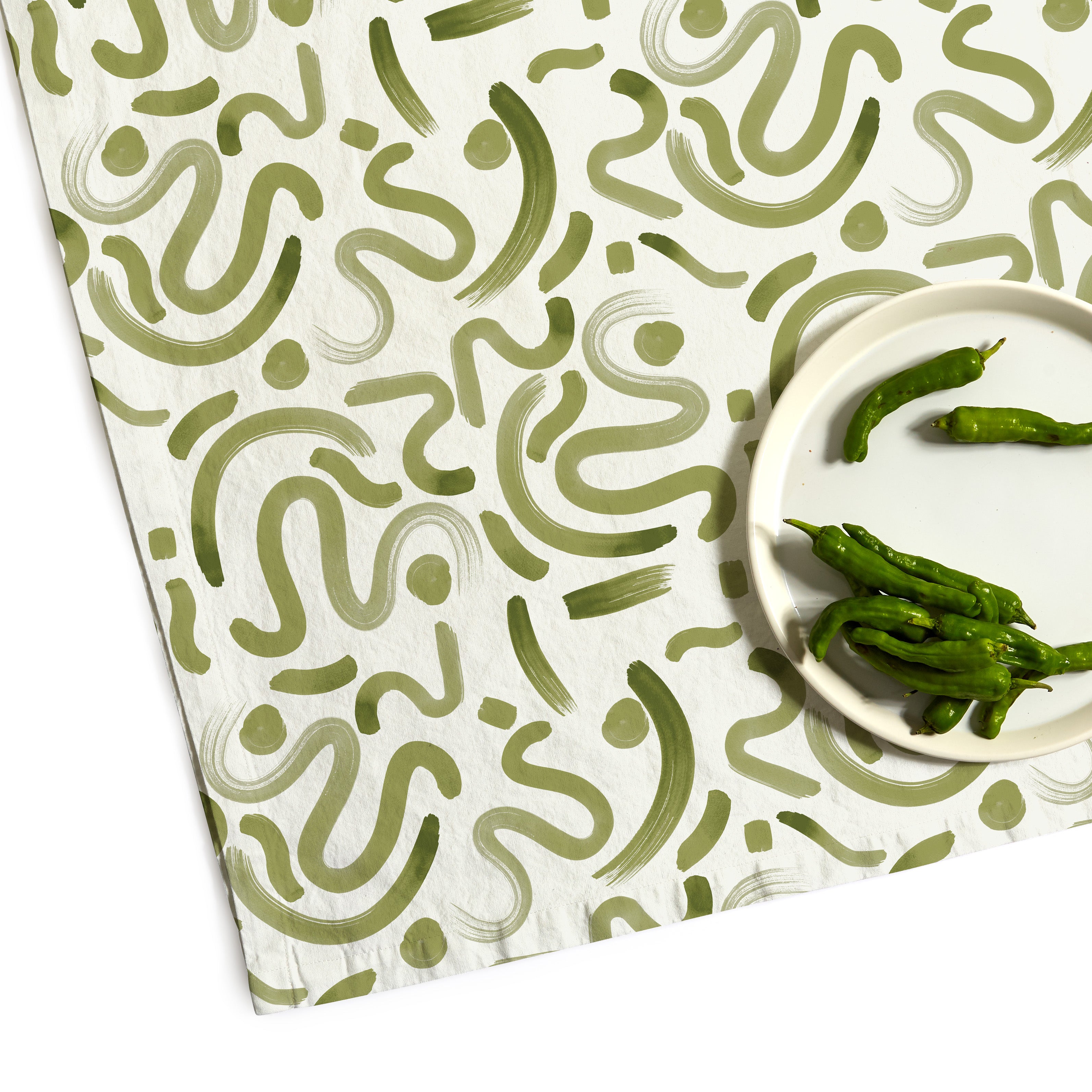 Moss Green Printed Tablecloth Corner Close-up with green peppers on top of white plate