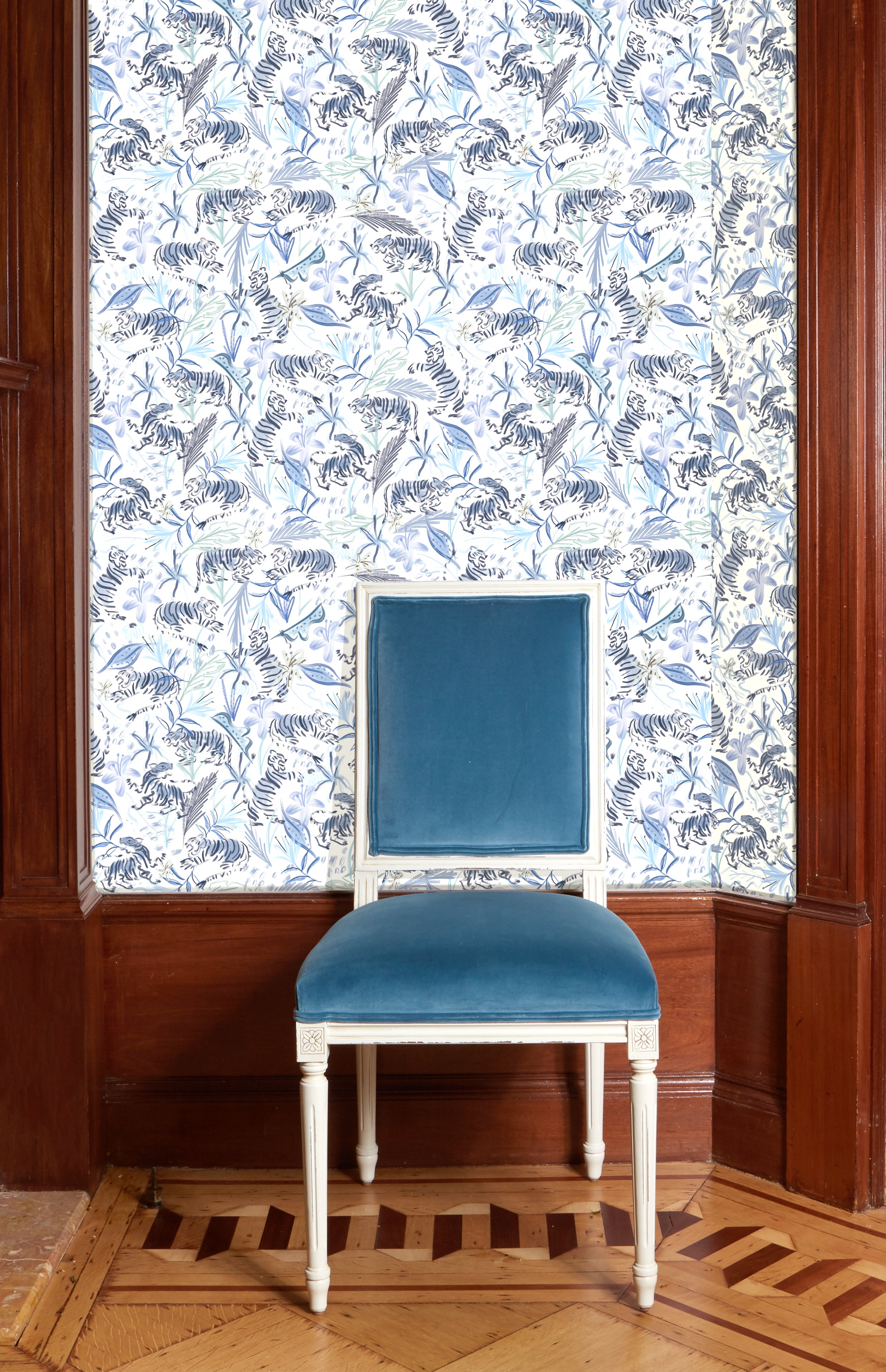Close-up of blue velvet chair in front of Blue With Intricate Tiger Design Printed Wallpaper 